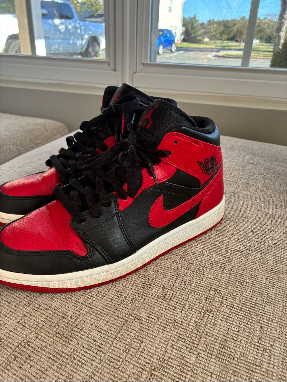 Jordan 1s Mid-Top Sneakers in Black and Red